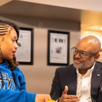Man and woman talking with each other while sitting at table